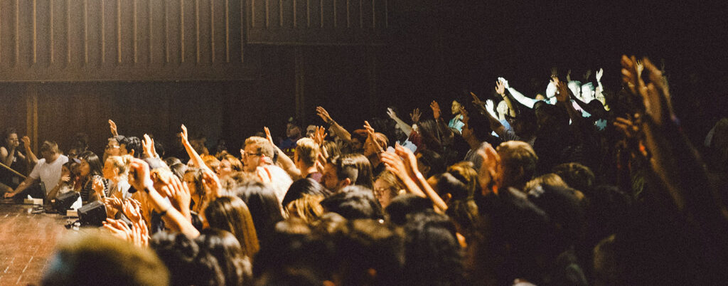 Crowd of people with their hands in the air