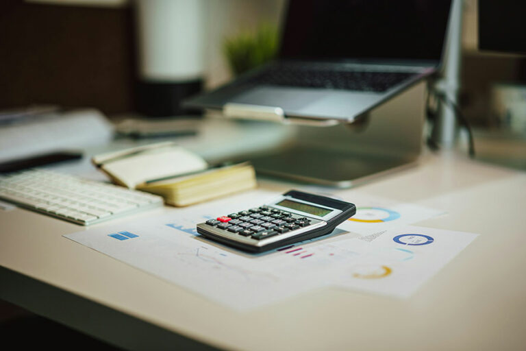 calculator and papers on desk