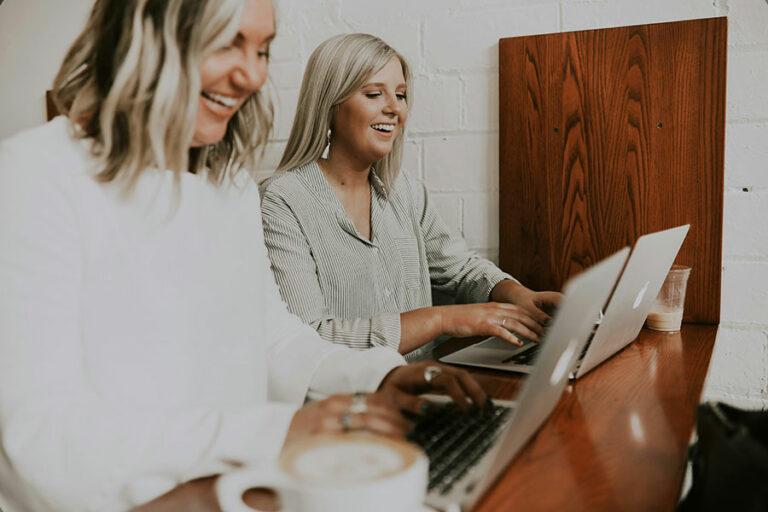 two women on laptops